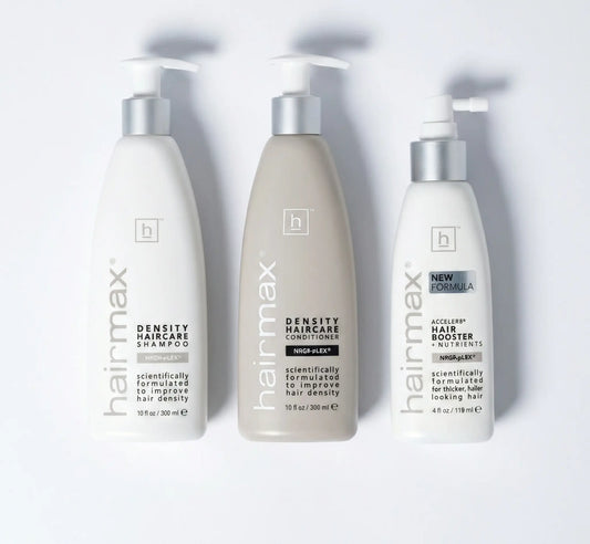 Three bottles of Hairmax hair care products on a white background
