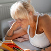 Older woman reading a book about hair loss